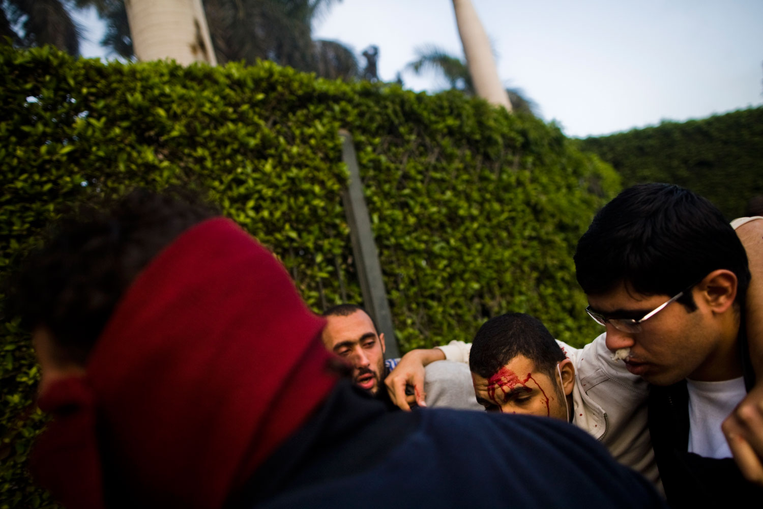 A wounded protestor is carried away after being injured during clashes with police near Tahir Square.