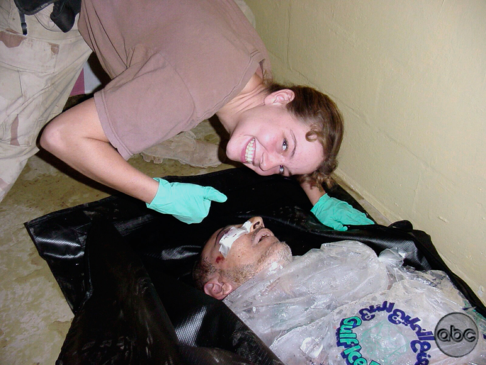 Army Spc. Sabrina Harman poses with the body of an Iraqi detainee at the Abu Ghraib prison in Baghdad, Iraq, 2003.