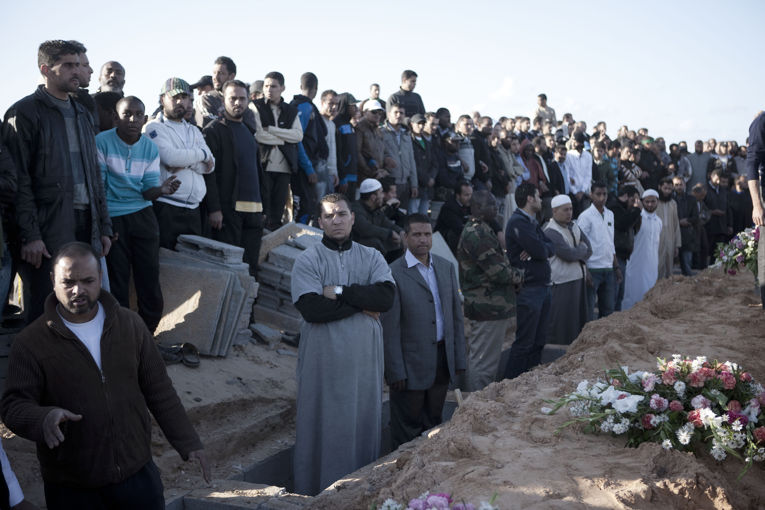 Tripoli residents bury some bombing victims at the martyrs cemetery in Tripoli