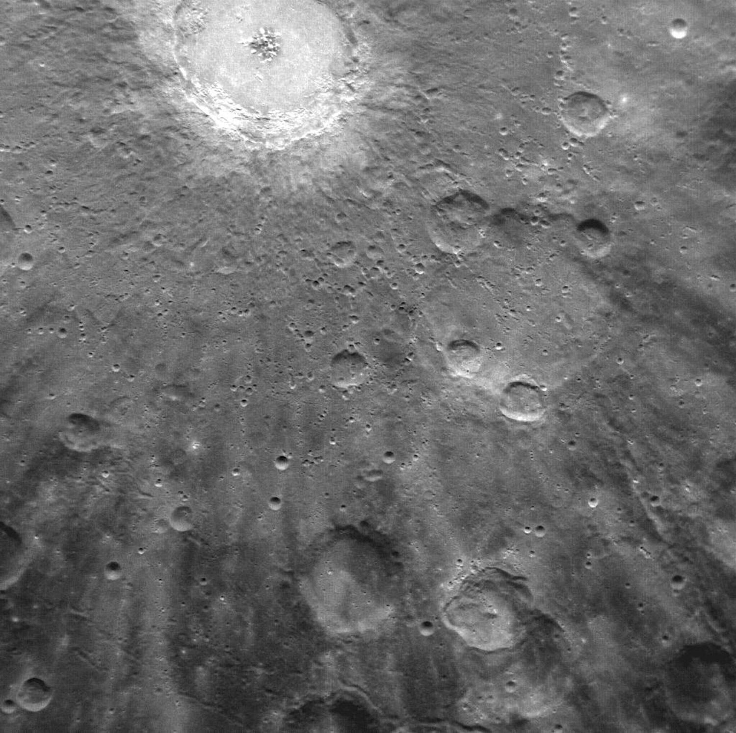 This is not the first time the Debussy crater—named for French composer Claude Debussy—has been photographed by Messenger, but it’s never before been captured in this detail. Rays, impact ejecta and secondary craters surround the central formation. Rich as such a closeup is, it doesn’t capture the true scale of the entire Debussy formation, whose rays stretch hundreds of kilometers.