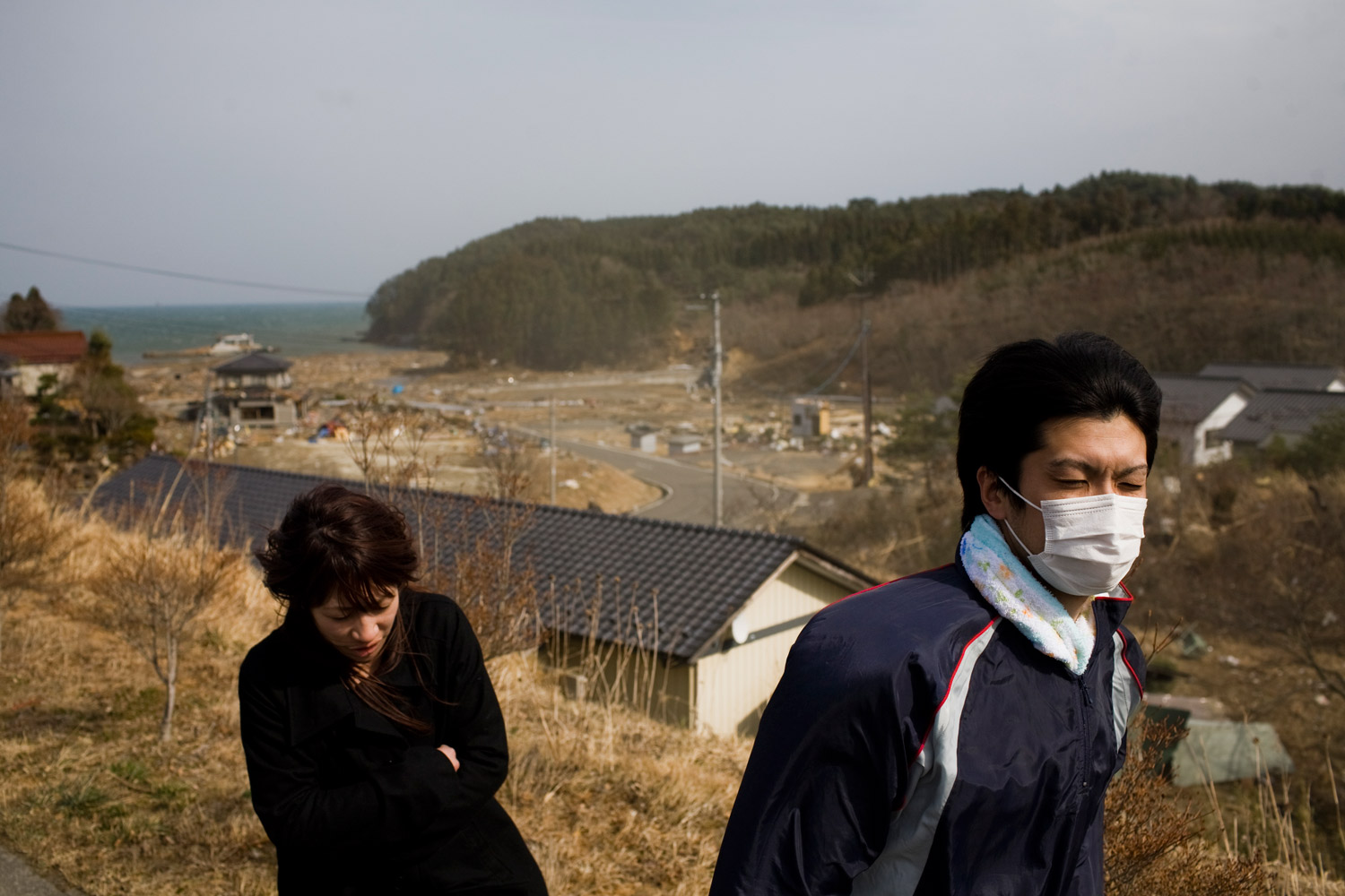 Locals tour the devastated coast in Kesennuma on March 14, 2011