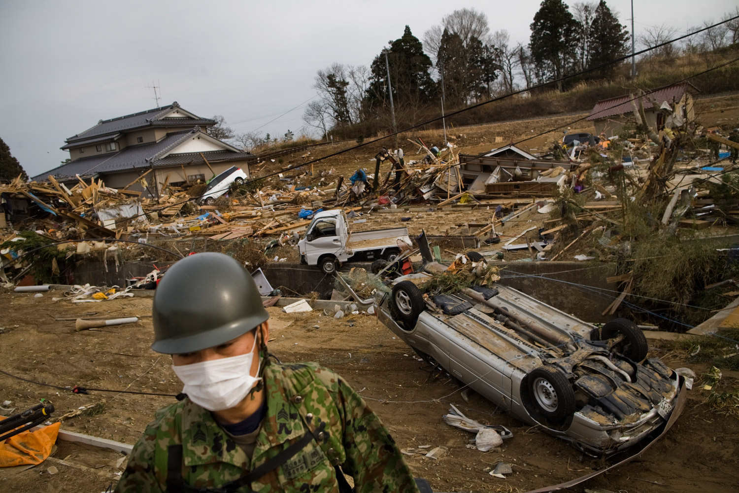 A member of Japan's Self-Defense Forces searches for survivors on March 14, 2011