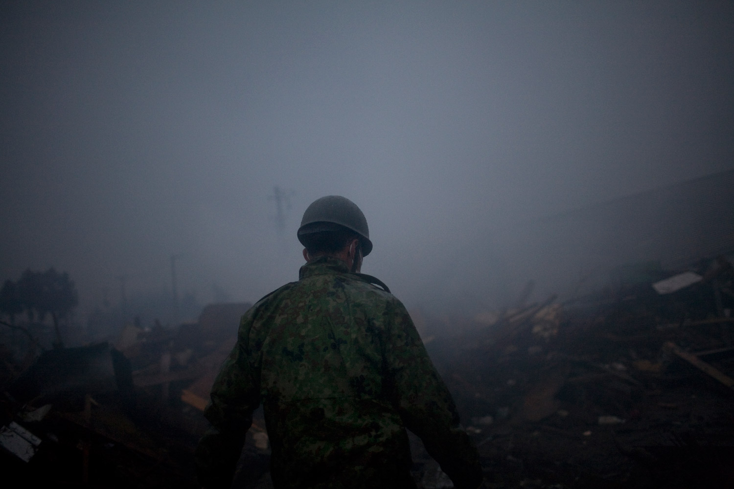 A soldier combs through debris looking for survivors in Natori on March 15, 2011
