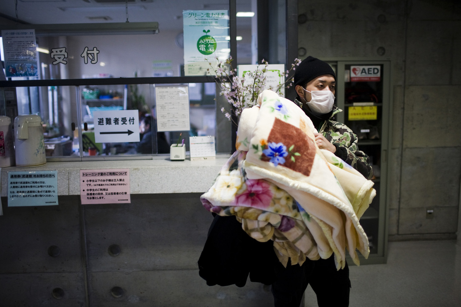 A man from an evacuation zone seeks refuge at a school gymnasium in Yonezawa on March 16, 2011