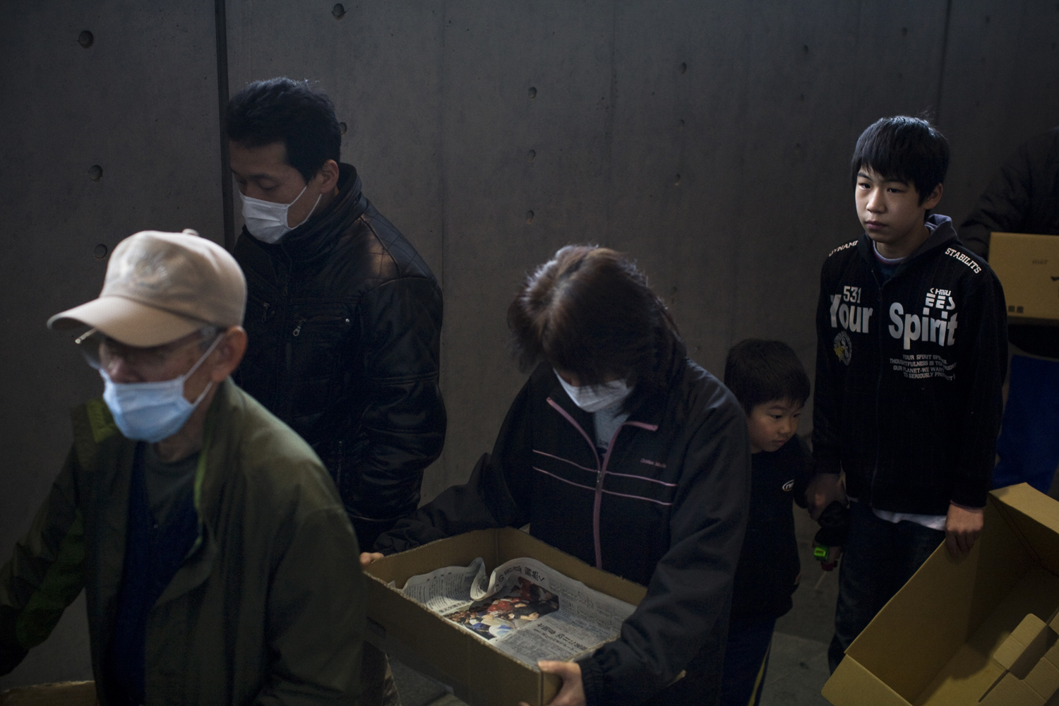 Evacuee's in Tokyo, many of which come from the Fukushima prefecture, wait in line for food at the Saitama Super Arena where close to 5000 people seek shelter and aid. March 22, 2011