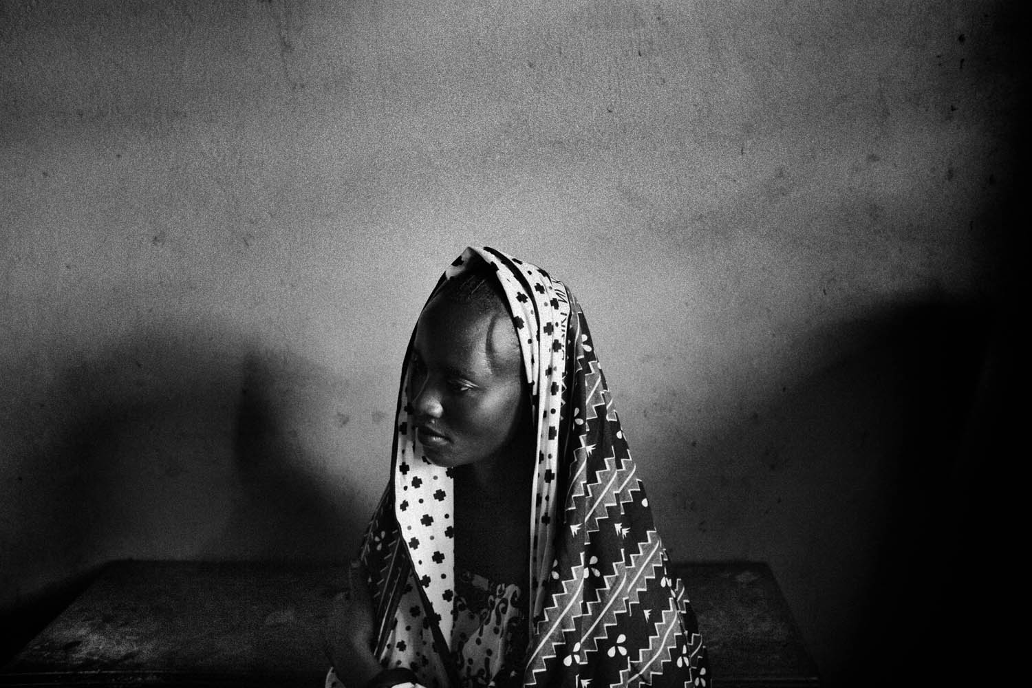 A 27-year-old victim of sexual violence, in a church in Bunia that doubles as a women's counseling center, 2006.  As the cases of rape grew in eastern Congo, the Pastor negotiated access to a centre for abused women in Goma. I recorded these images for an article on rape as a war crime.