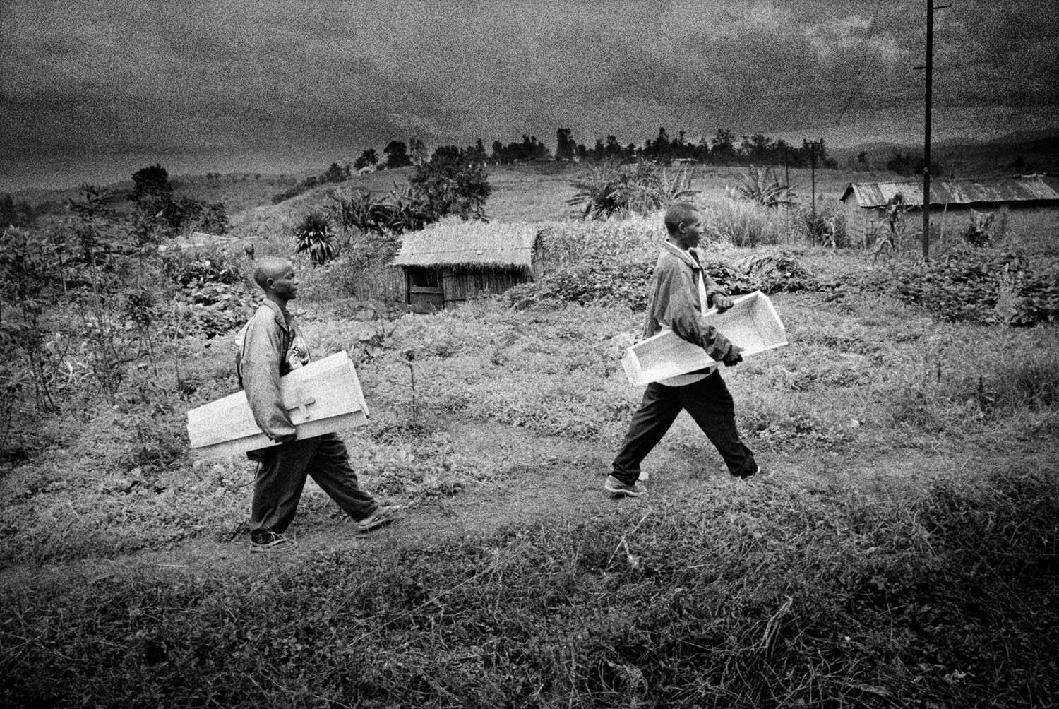 The coffin arrives for the burial of 8-month-old Sakura Lisi, the daughter of a gold miner in Mongbwalu, northeastern Congo, 2004. She died from anemia brought on by malaria.  As the war continued I concentrated on shooting the ultimate price of this conflict, the death of loved ones.
