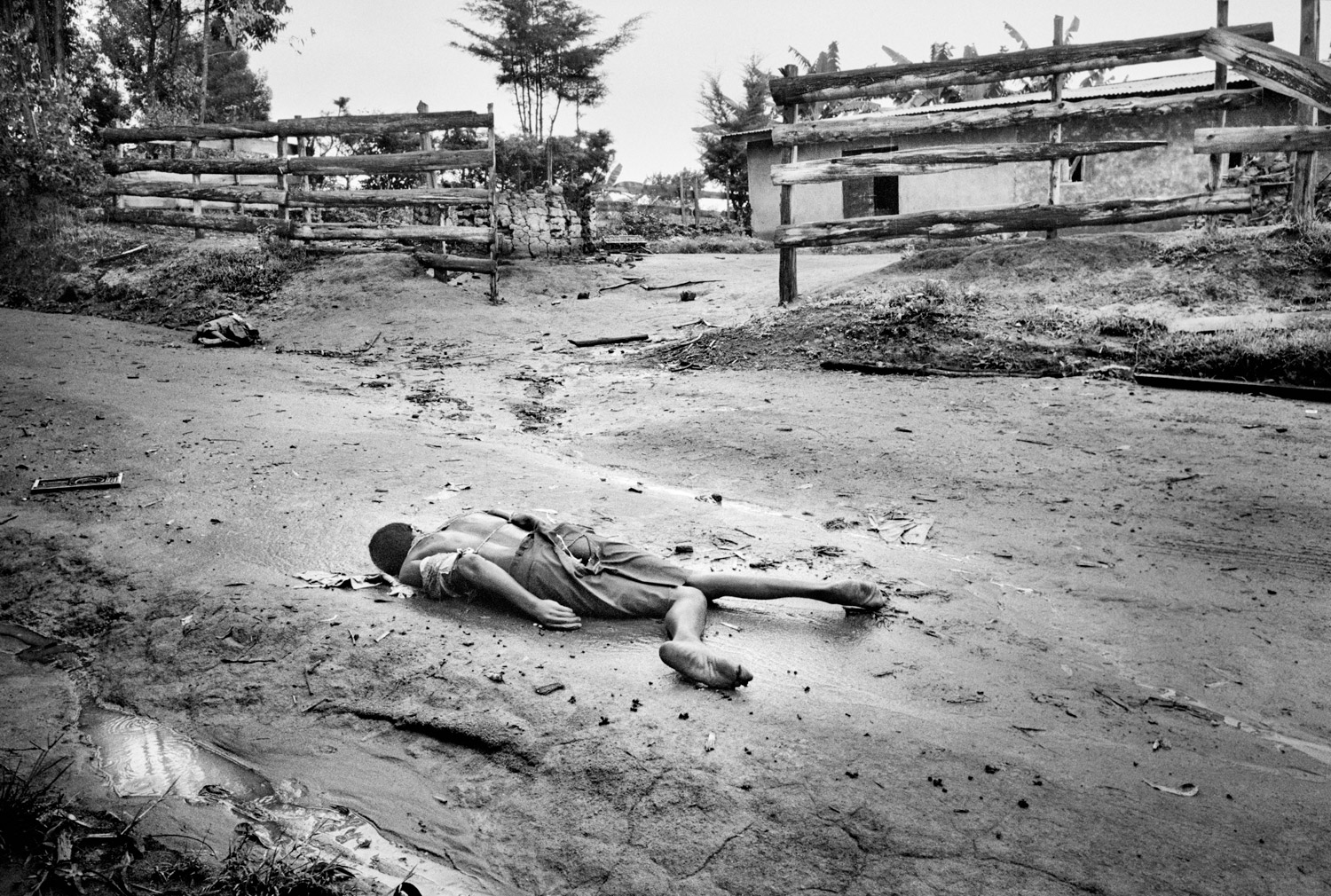 Two dead bodies of Hema men lie on a road after being executed by Lendu militias north of Fataki, Democratic Republic of Congo, in August 2003. They were both bound and impaled before being shot and their ears had been bitten off in the ritual killing.