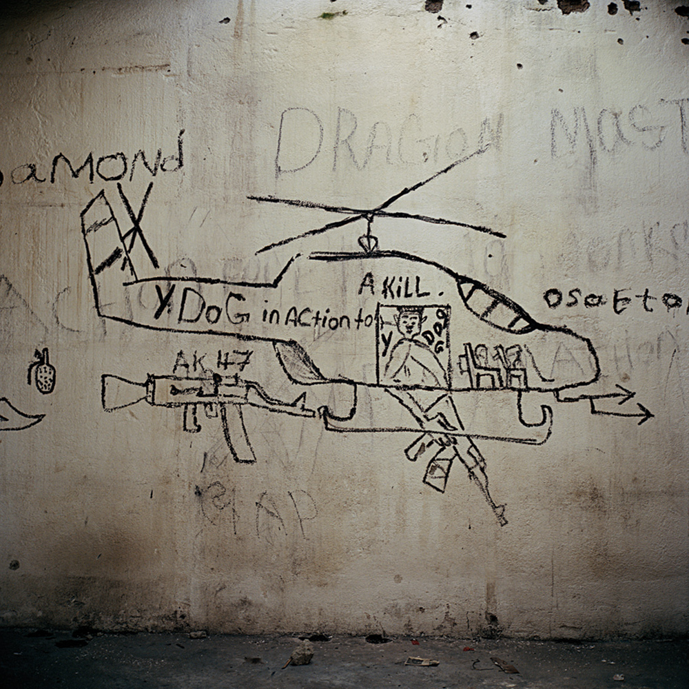 Grafitti. The name above the helicopter, “Dragon Master,” refers to Mandingo frontline commander Mohammad Konneh, known as k-1. Sergeant Killi Town, Bong County, 2004.