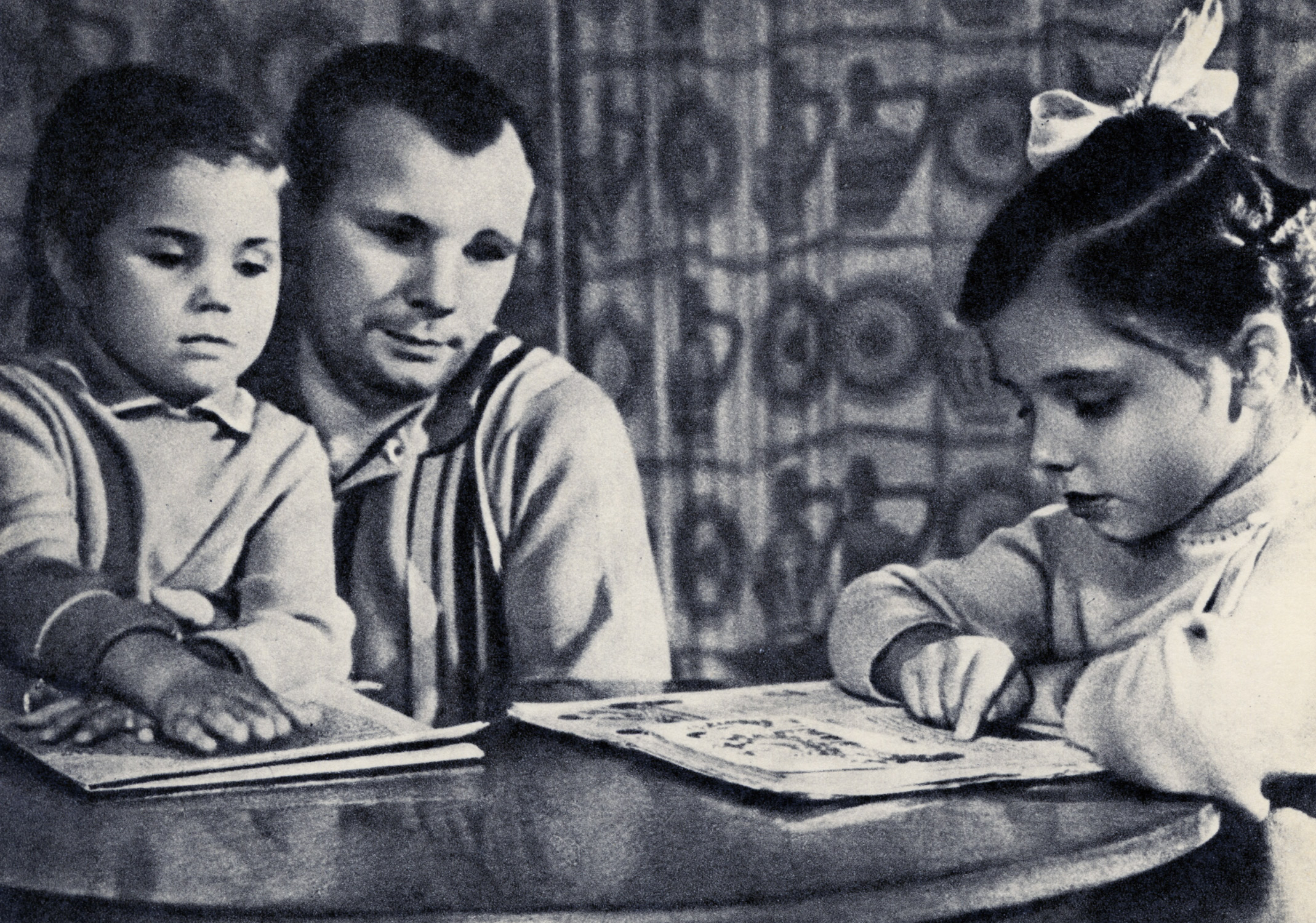 Family Man: Gagarin is pictured with his daughters Lena and Galya. The postcards in this gallery are drawn from an album assembled during Gagarin's lifetime by an unknown admirer.