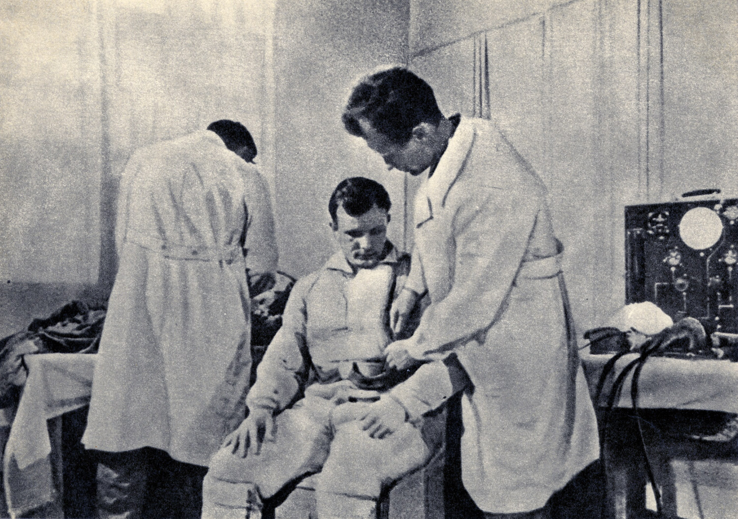 Drawn from the film First Trip to the Stars, Gagarin is shown being examined before his flight