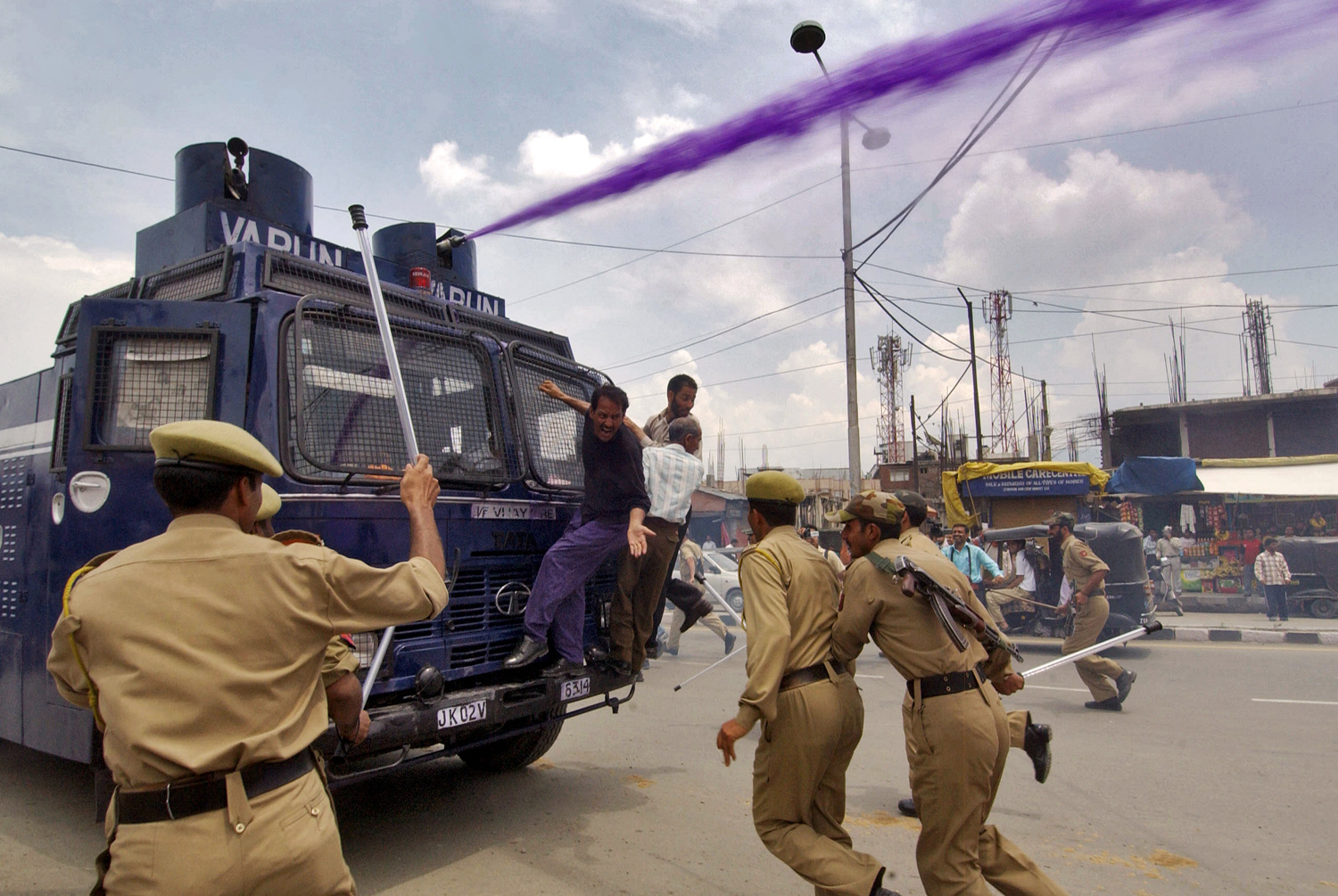 Indian police use a water cannon and batons against Kashmiri government employees in Srinagar on June 12, 2008.