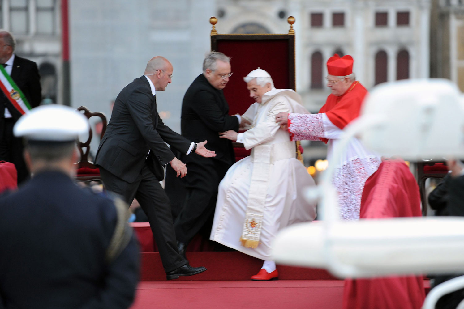 May 7, 2011.  Pope Benedict XVI nearly fell at St. Mark’s Square in Venice. Cardinal Angelo Scola, right, and two other Vatican officials helped him regain his red-shoed footing.