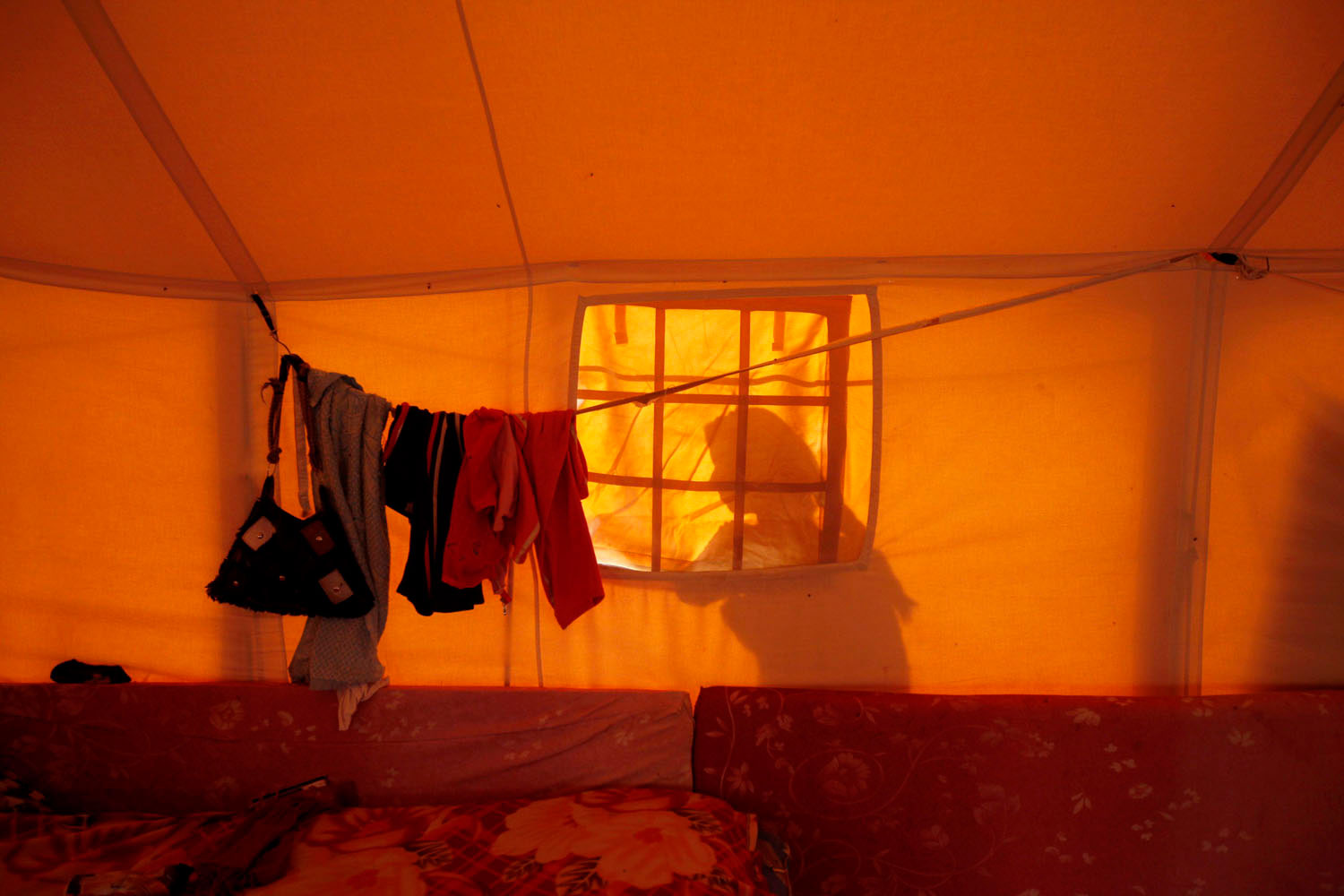 May 9, 2011.  A Libyan woman works outside her tent in Dehiba, near the Libya-Tunisia border. An estimated 20,000 displaced people have ended up in Dehiba.