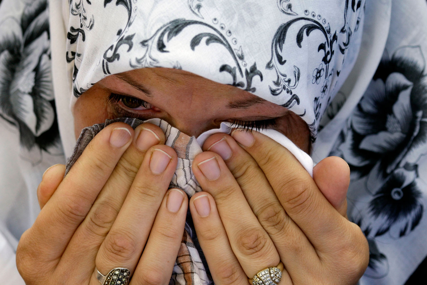 May 12, 2011.  A Bosnian Muslim woman reacts, near the  coffin of her relative during a mass funeral for Bosnian Muslims in Bratunac, 140 kms northeast from Sarajevo, Bosnia. Thousands of Bosnian Muslims attended at funeral of 16 men, women and children killed by Bosnian Serb forces at the beginning of the Bosnian 1992-95 war in Bosnian town of Bratunac. All of the bodies were found and exhumed from a mass grave and identified by DNA method.