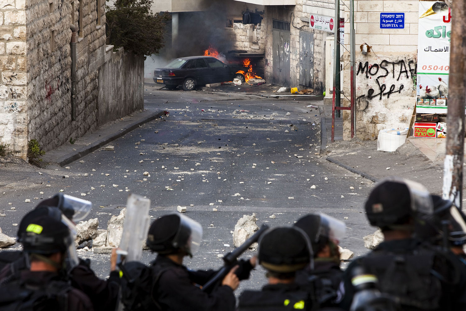 Israeli police take position at the opposite end of the street during clashes with Palestinian youths. The days leading up to the  Nakba  on May 15th — when Palestinians commemorate their exodus and Israel's independence of 1948—are particularly tense.