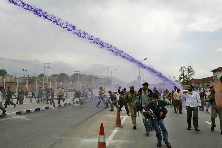 Police shoot water cannons as Jammu Kashmir state government employees shout anti government slogans during a protest outside the civil secretariat in Srinagar, India, May, 5, 2008.