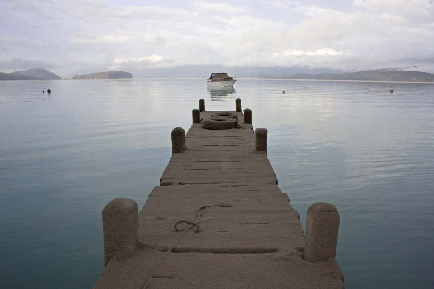 The pier of Puerto Arauco at Nahuel Huapi Lake is seen covered by sand and volcanic ash from the Chilean Puyehue-Cordon Caulle volcano in Villa La Angostura, southern Argentina, Friday, June 17, 2011.  The volcano started erupting on June 4 after remaining dormant for decades.