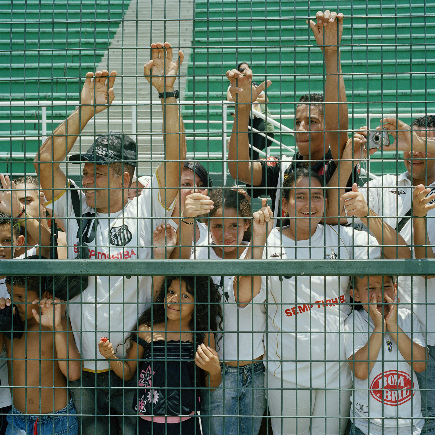 Santos fans, familiarly known as Santistas, watch through the fence as the women’s team celebrates their Campeonato Paulista de Futebol Feminino championship in São Paulo, Brazil. Once considered a disgrace to the much celebrated men's game, futebol feminino in Brazil has finally started to be accepted among male and female fans. (November 27, 2010)