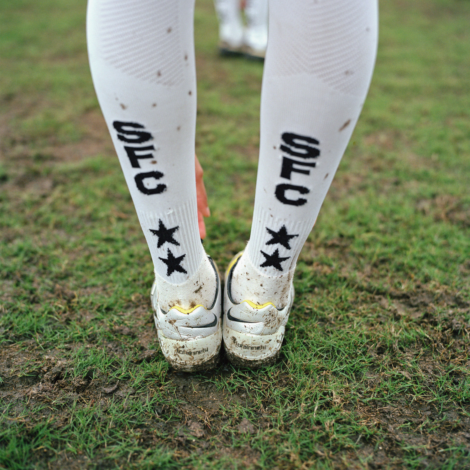Detail of Santos Futebol Clube (SFC) socks during a team stretch at training.  All of the women on the team are now provided with washed uniform kits for every practice and game similar to the men’s teams.  In the past, the women on the team were responsible for washing their own uniform kits by hand. (October 29, 2010)