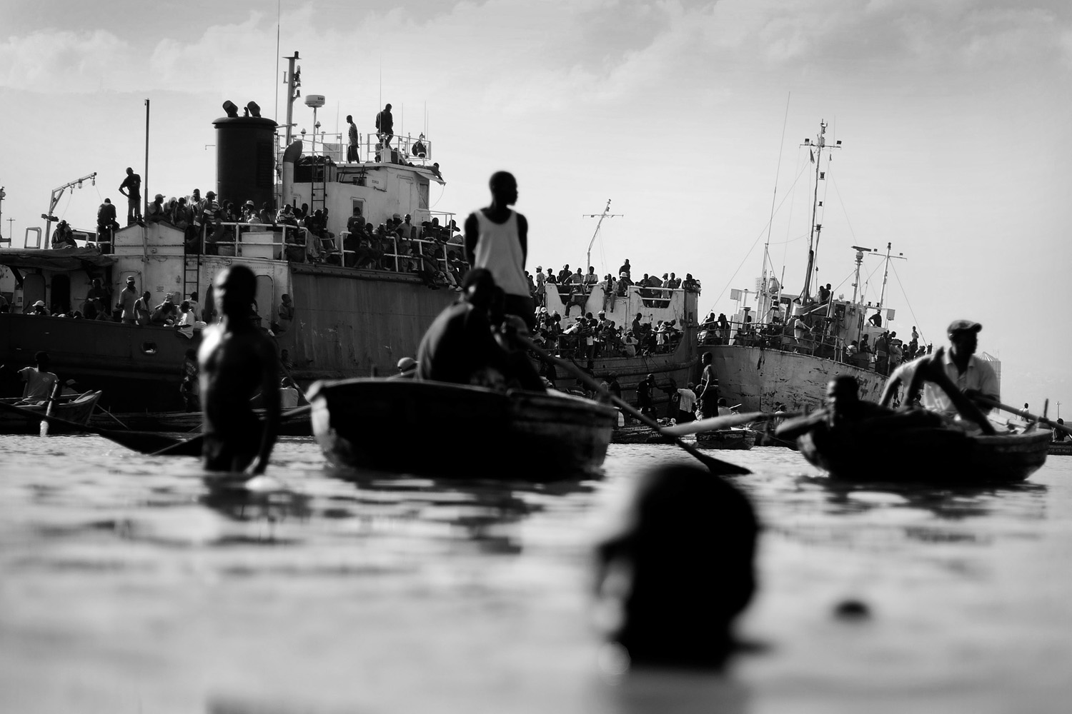 Outside of the main harbor in Port-au-Prince, thousands of Haitians try to flee the country by boat.