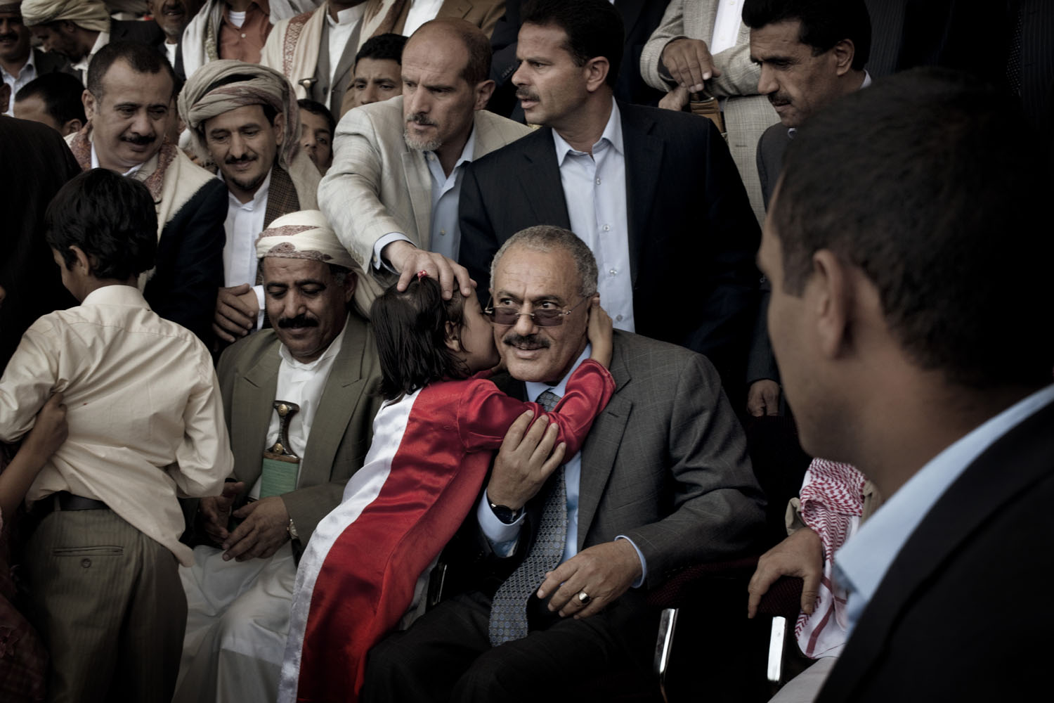 A young supporter kisses Yemeni President Ali Abdullah Saleh during a pro-government rally in Sana'a. In a defiant speech to thousands of flag-waving supporters in the Yemeni capital, Saleh declared:  We will confront a challenge with a challenge.  May 13, 2011.