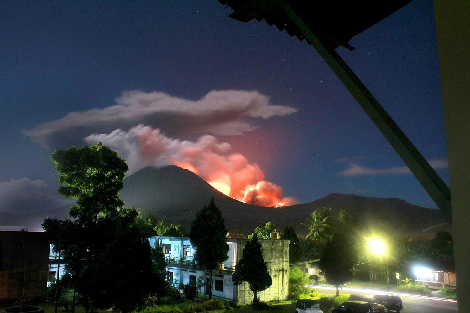 15 July 2011. Mount Lokon erupts as seen from Tomohon, North Sulawesi, Indonesia. Indonesian authorities raised the alert at the volcano on Sulawesi island to the highest level and urged the evacuation of the danger zone. More than 30,000 people live near the volcano, according to the local government.