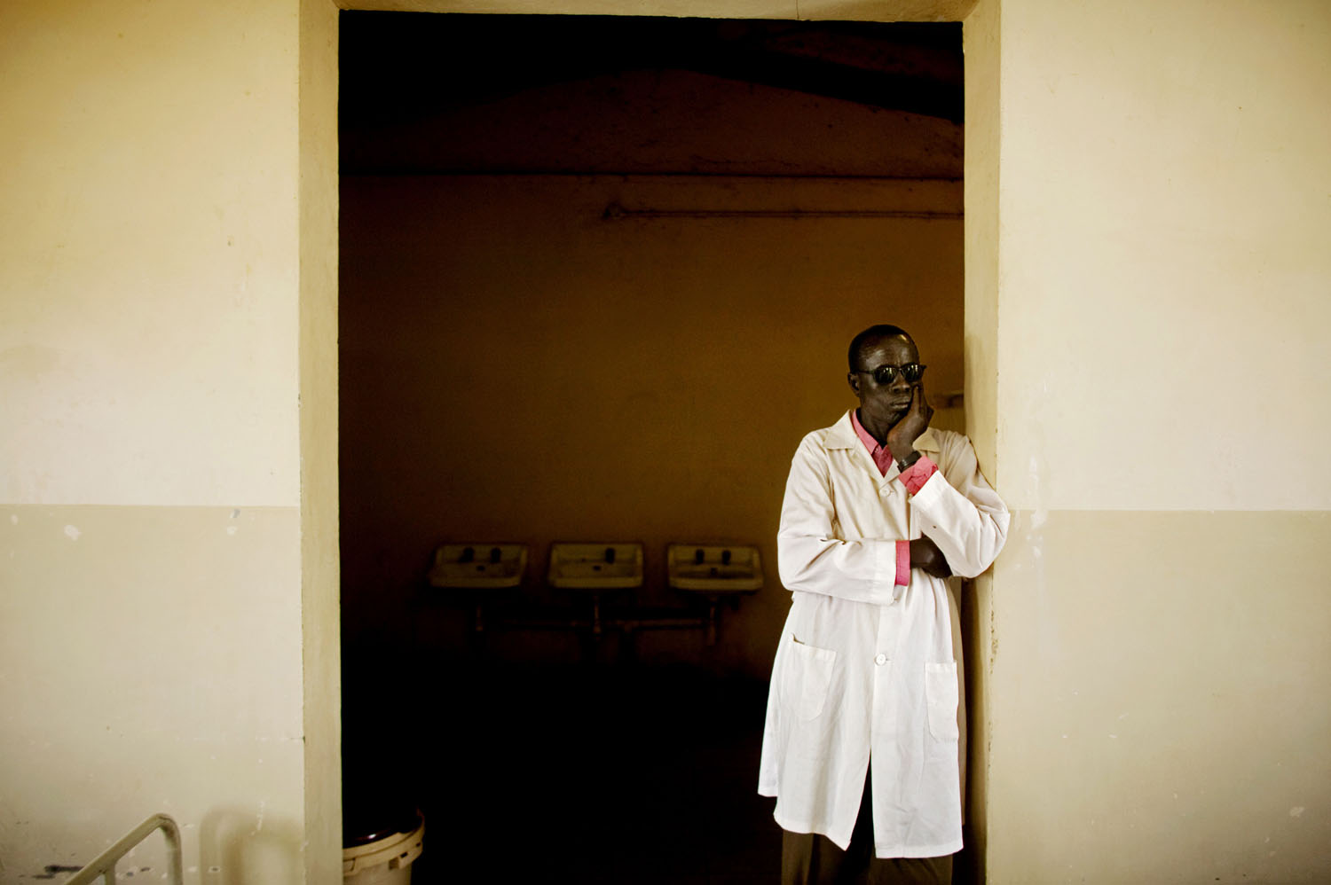 A southern Sudanese doctor looks out over the male surgical recovery ward in the main hospital in Bentiu, the capital of southern Sudan's oil rich Unity State.