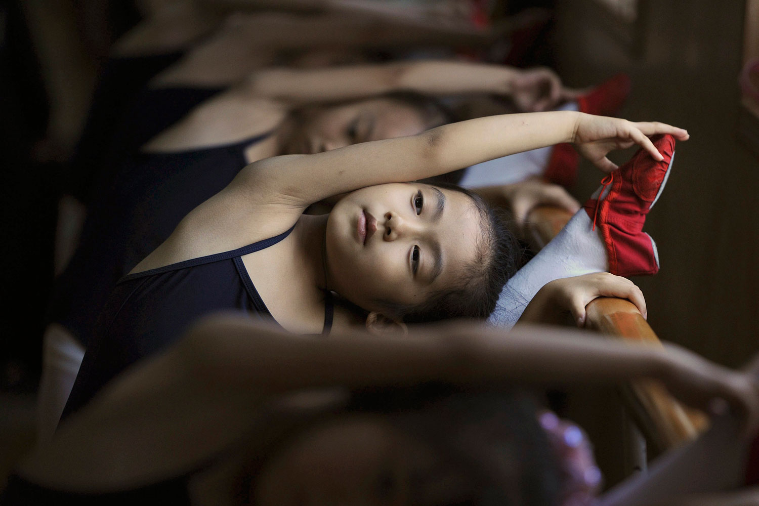 July 9, 2011. Children stretch during a ballet lesson at a dancing school in Hefei, Anhui province, China.