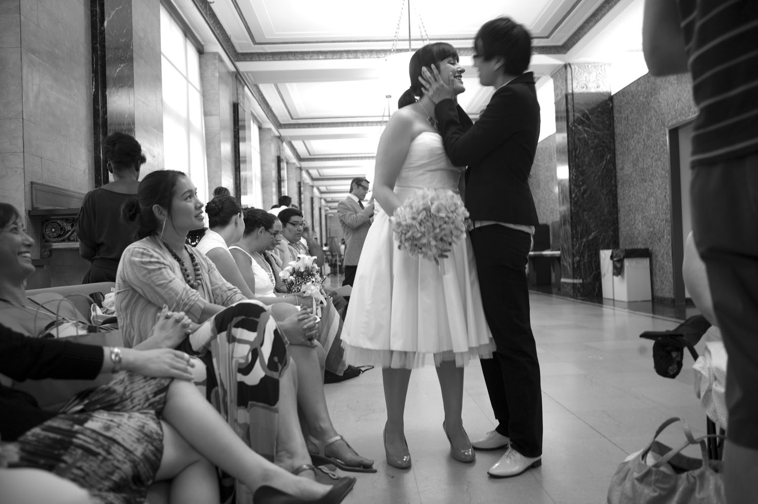 Inside the City Clerk's office, couples, families, witnesses, and well-wishers waited in lines for hours to marry. Melissa Barsamian, in white, and Dorothy Kim, have been together for more than four years.