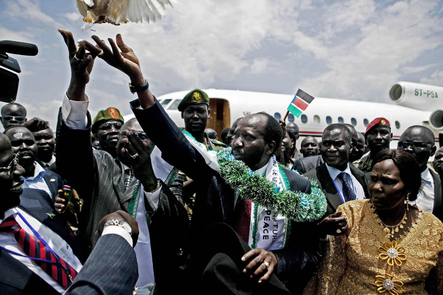 Salva Kiir (green sash), the President of the Government of South Sudan and Riek Machar (2nd on left) release a dove upon Kiir's return from the United States. The two men were bitter enemies during the latter years of the civil war in southern Sudan. Machar aligned with the northern government in Khartoum and used his forces against Kiir and other SPLA commanders. The relationship is emblematic of the tense and distrusting alliances that define the southern political landscape.