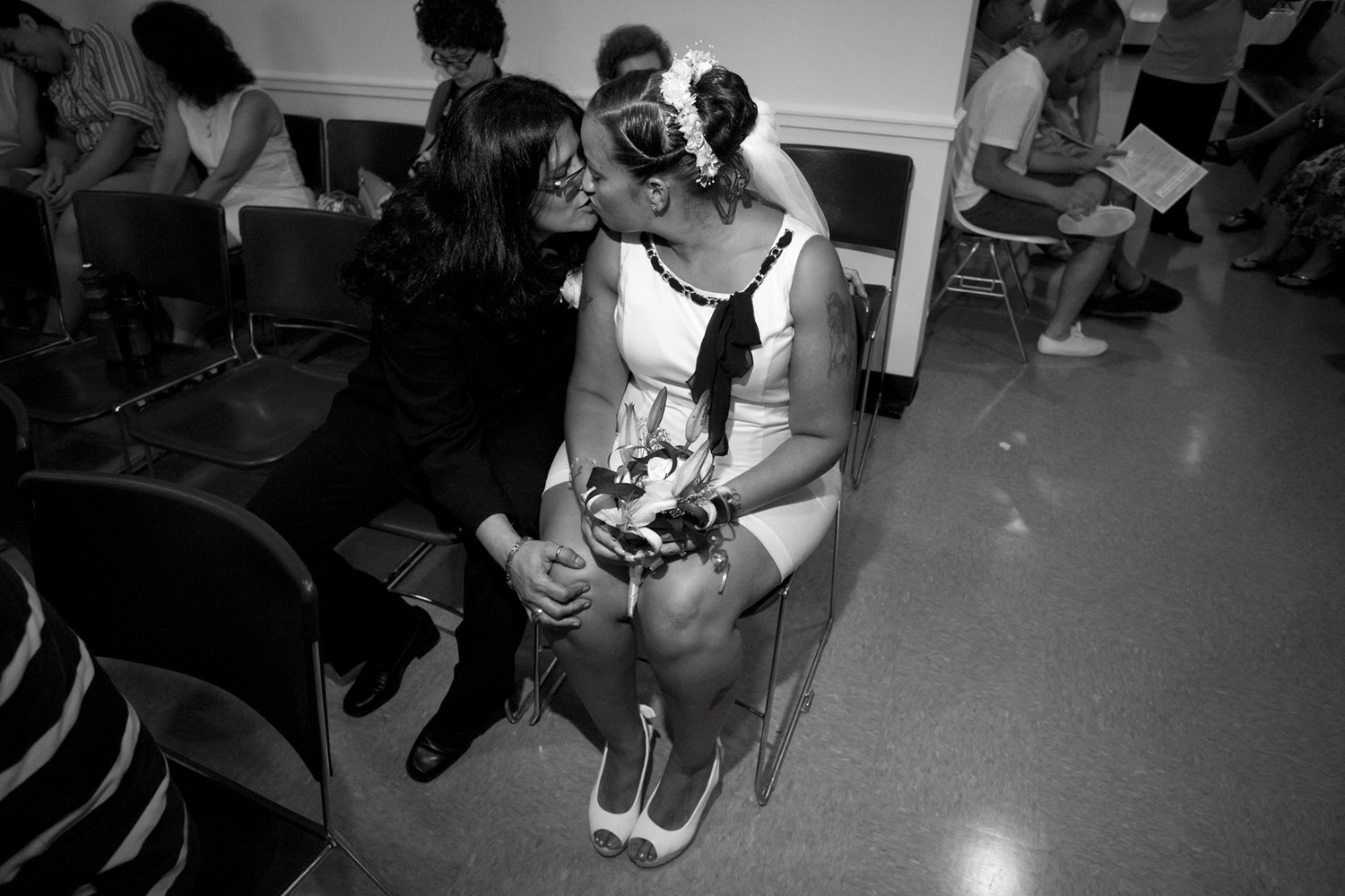 Same sex couple Lilliam Hernandez and Sabrina Velez share a kiss while waiting to be called for their marriage ceremony. The two have been together for 6 months.