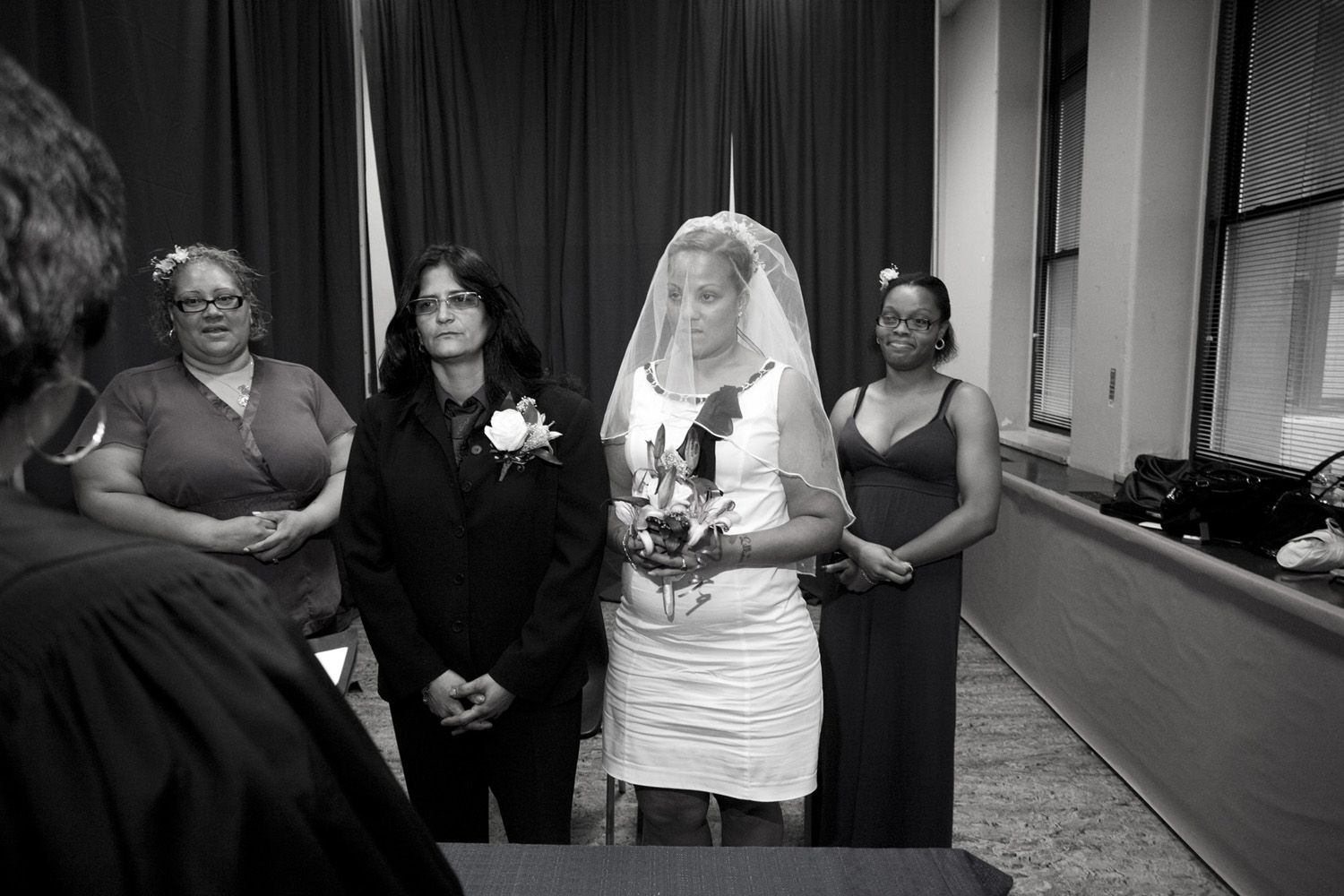 Same sex couple Lilliam Hernandez and Sabrina Velez get married while maids of honor Gloria Torres and Latianna Paraison look on.