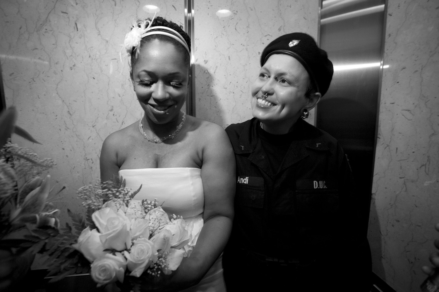 Same sex couple Claudette Lankford and Andrea Lankford Weaver smile in the elevator just after their wedding ceremony at Brooklyn Borough Hall.