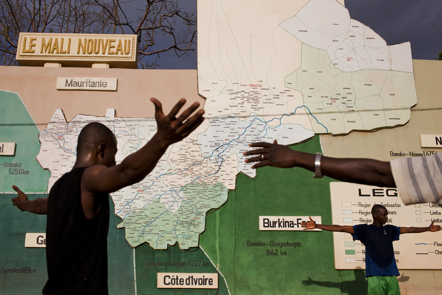 Mali, Bamako, 2011. 
                              Men exercise in front of a map of Mali and its surrounding countries.