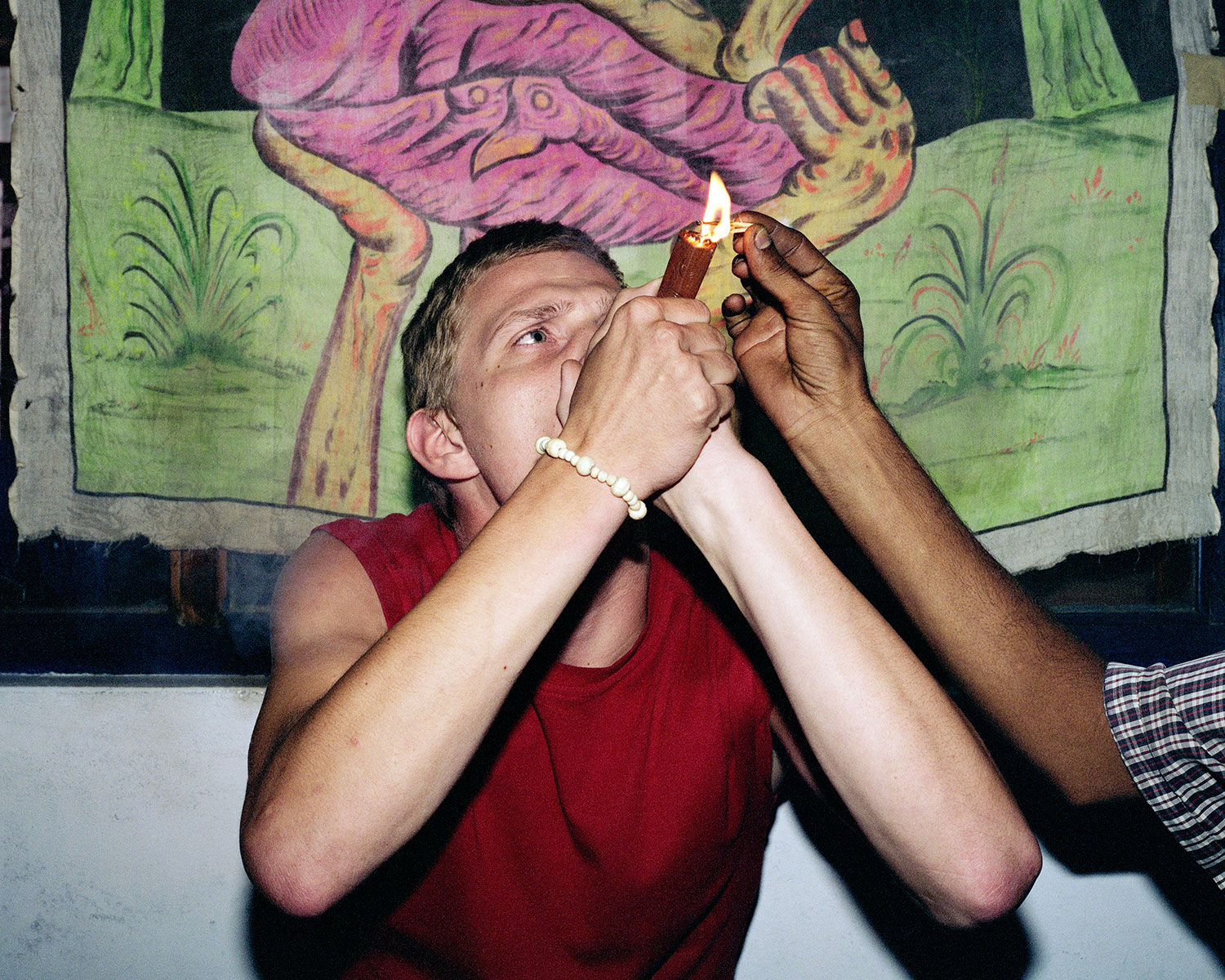 A tourist smokes a chillum pipe filled with charas, a form of hashish in Old Manali, India, August 2007.