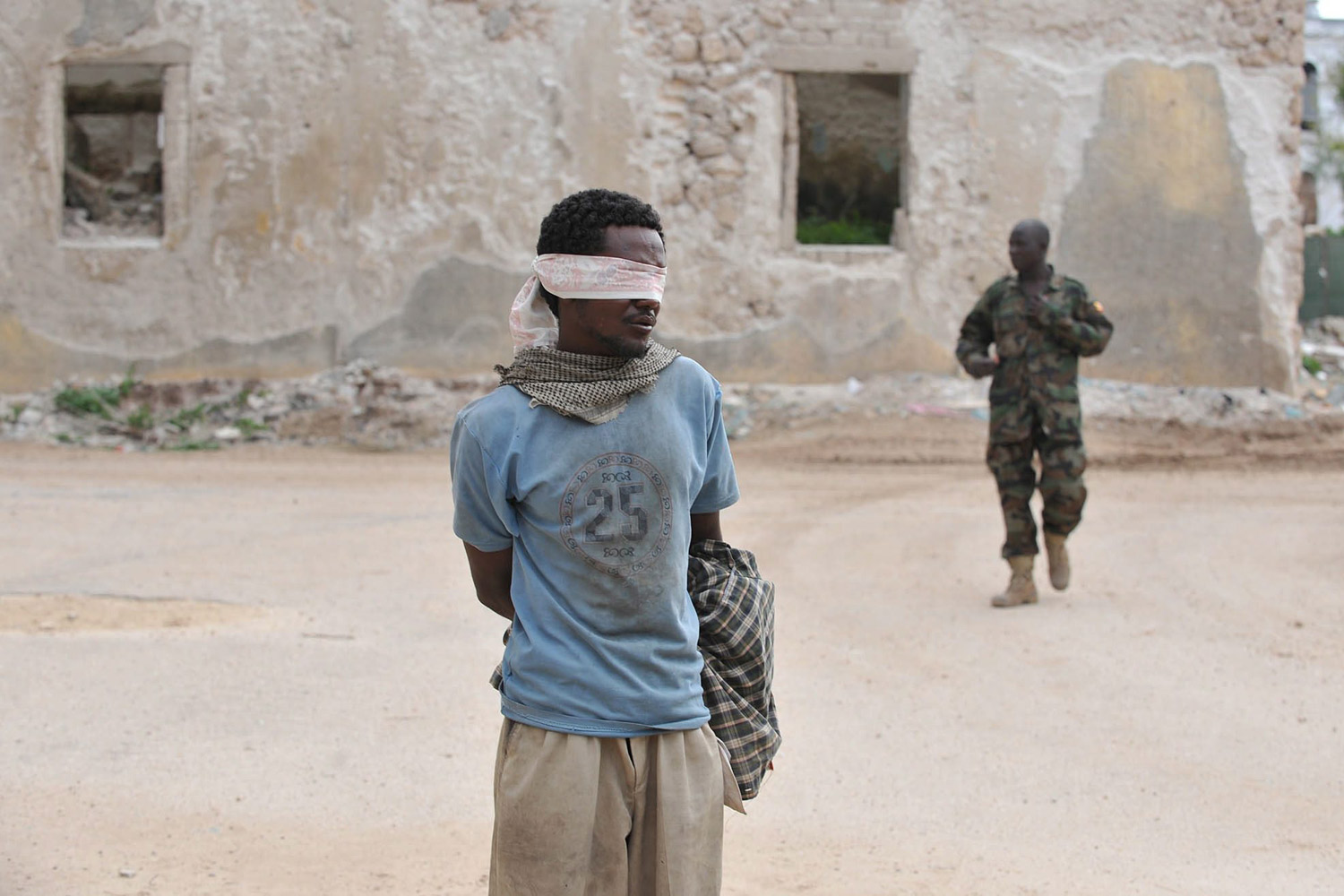 August 6, 2011. A suspected rebel member of Al-Shabab was captured by Amisom (African mission in Somalia) in Mogadishu shortly after the militant group withdrew from the last four districts that they held after heavy fighting through out the night, Somalia. Reports state that the conflict has hindered aid efforts in the famine-hit country, with the militia barring some aid agencies from central and southern areas it controls.