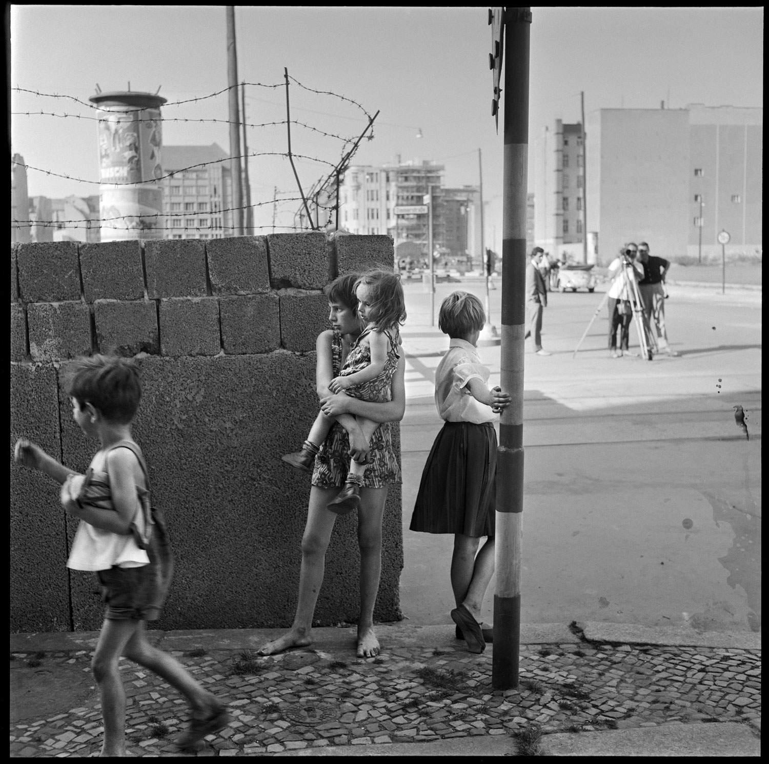 Children playing near a portion of the Berlin Wall at the time of its construction, Friedrichstrasse near Checkpoint Charlie, West Berlin, Germany, August 1961
