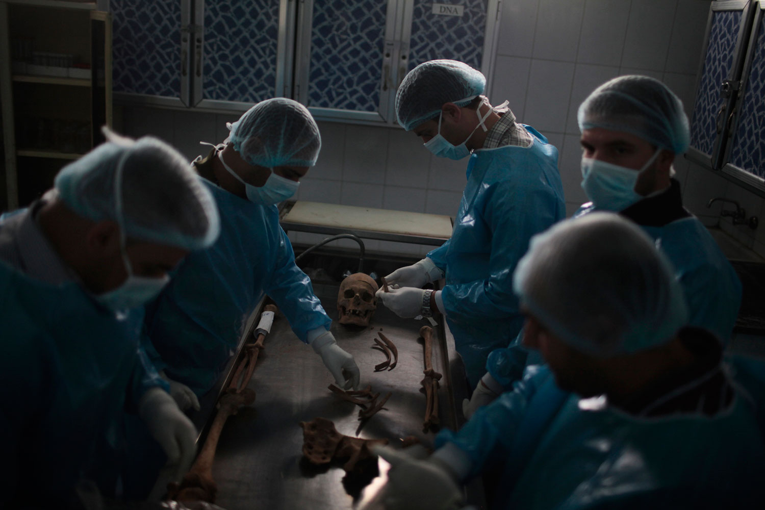Baghdad, Iraq. May 2, 2011.
                               This group of forensic anthropologists had the grisly task of excavating mass graves found throughout Iraq, and identifying exhumed remains, some decades old. In the same morgue, fresh bodies of those killed in conflict streamed in.