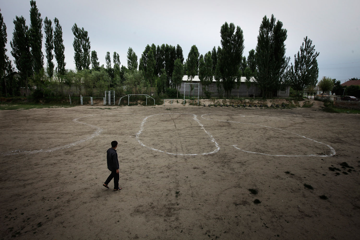 Uzbek enclave near Osh, Kyrgyzstan. June 17, 2010.
                               Ethnic Uzbeks painted a large SOS symbol on a soccer field, hoping that planes from Uzbekistan would see them and heed their call for help, when ethnic violence broke out between the Kyrgyz majority and Uzbek minority in Kyrgyzstan.