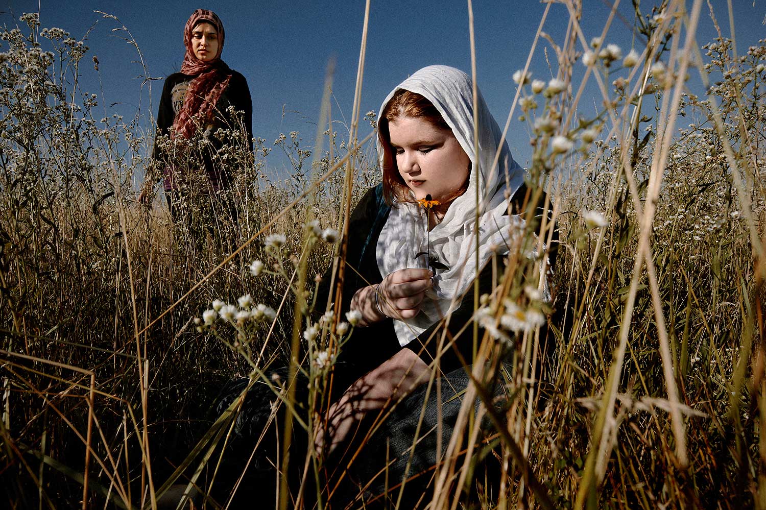 Caitlyn Green, right, in a field outside Columbia, Mo., July 2, 2010. Green lives in a rural town and converted to Islam more than a year ago, but her Catholic family does not accept the decision.