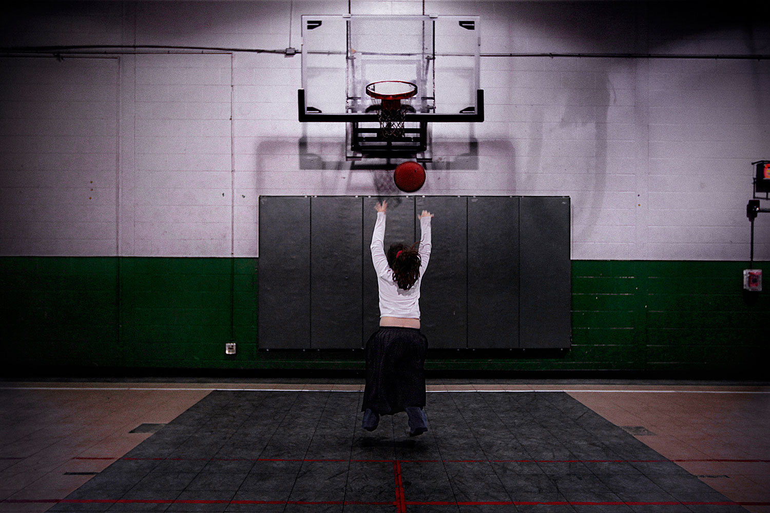 Shameen Pasha, 9, plays basketball alone at the gymnasium of her school at Villa Park, Ill., April 24, 2010.