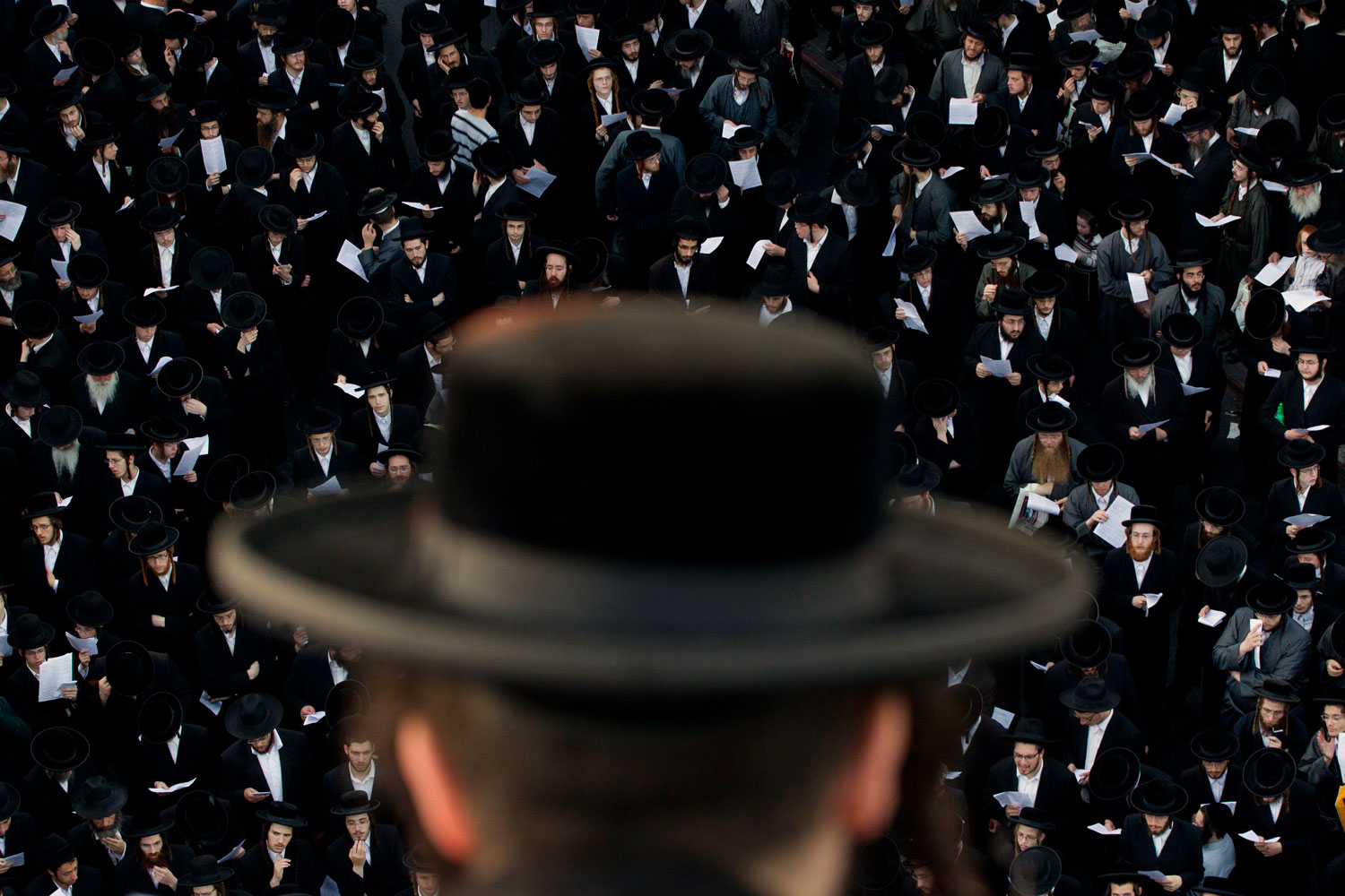 August 11, 2011. Ultra-Orthodox Jews attend a prayer as they gather in the religious neighborhood of Mea Shearim to protest against summer events organized by the city council, Jerusalem.