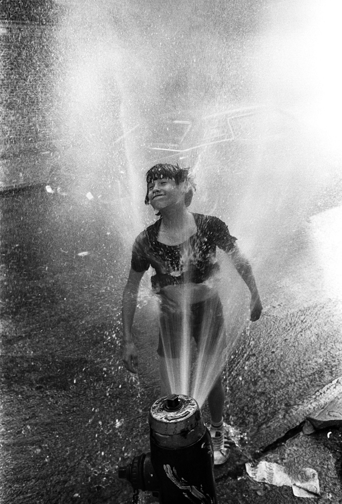 Cooling off in a fire hydrant, from Bronx Boys (FotoEvidence, 2011) by Stephen Shames.