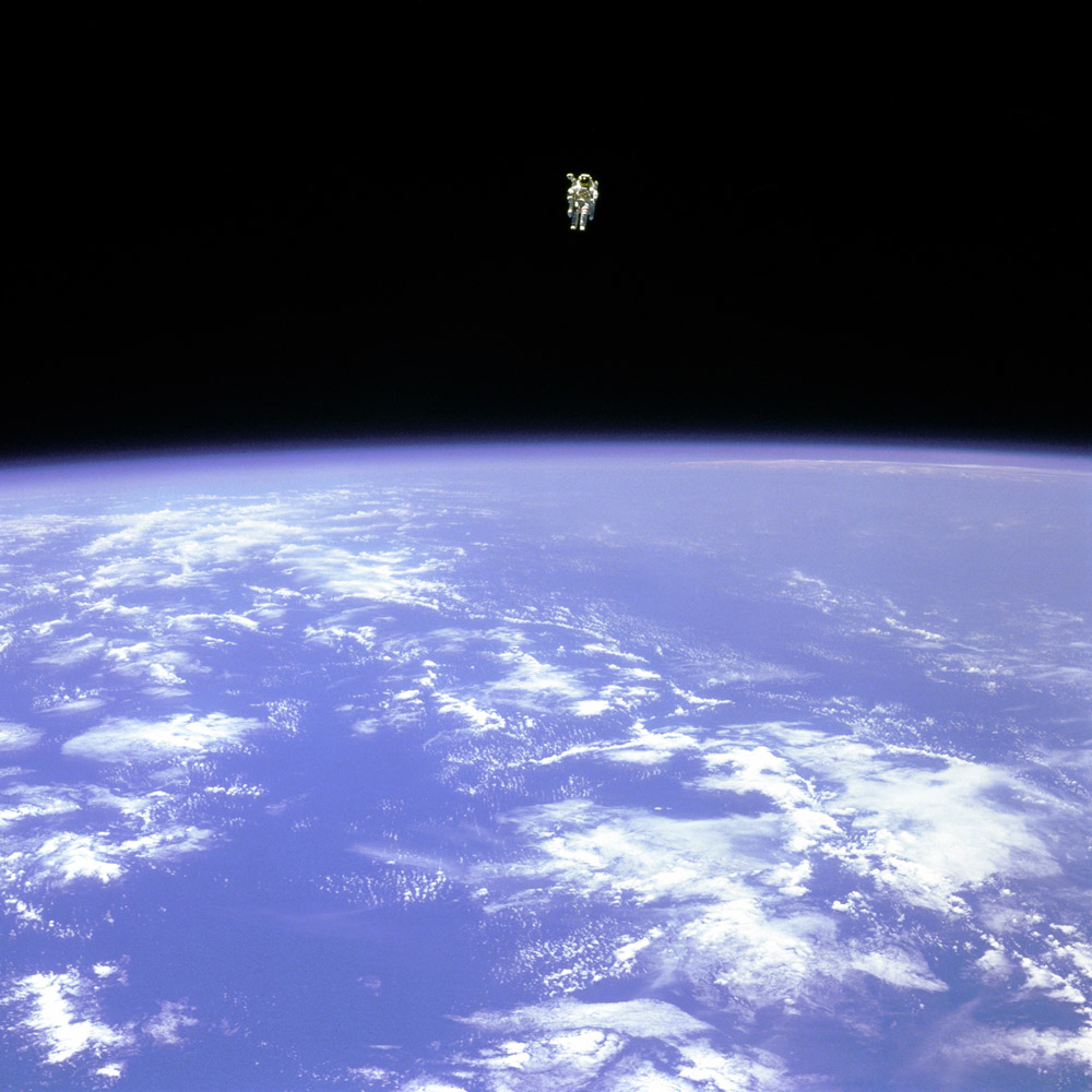 Mission specialist Bruce McCandless II uses a nitrogen jet propelled backpack, known as the Manned Manuevering Unit, to float away from the Space Shuttle Challenger, February 12, 1984.
