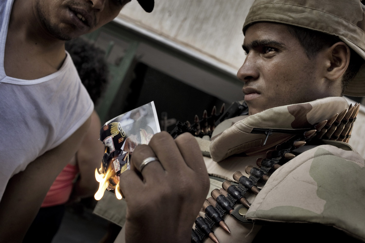 Libyan rebels burn a photograph of Muammar Gaddafi, August 25, 2011.