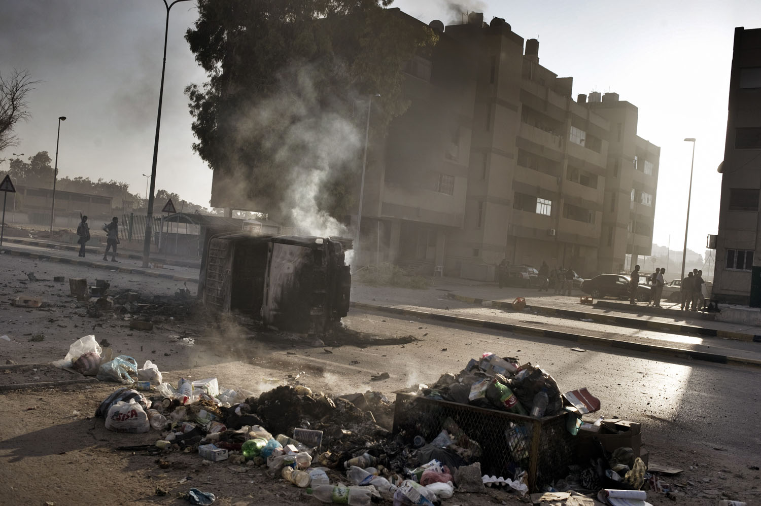 Vehicles and trash burn on a street in the Abu Slim neighborhood in Tripoli, August 25, 2011.