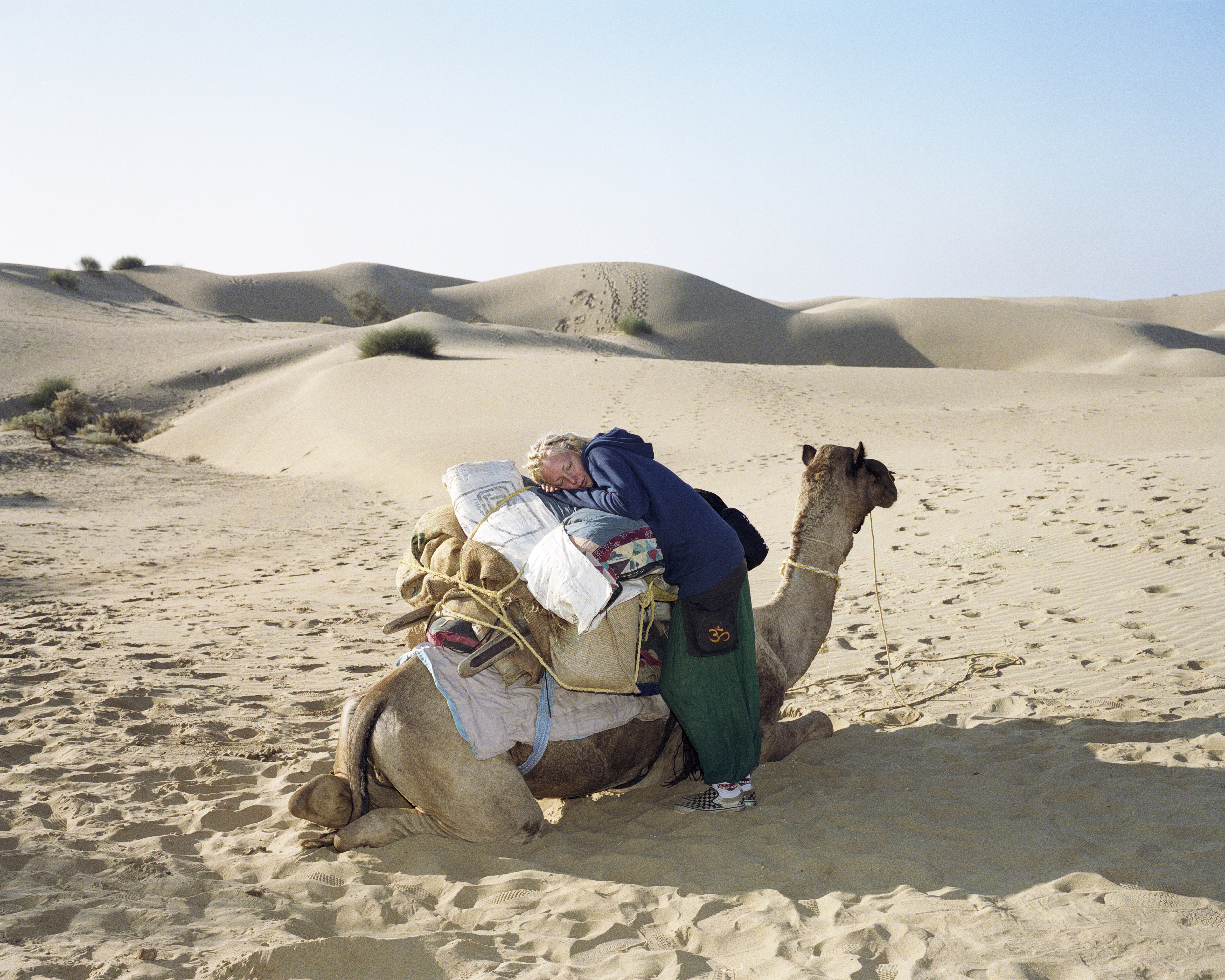 In the Thar desert, near to the Pakistani border, a Swedish backpacker waits for her camel safari to continue in Jaisalmer, India, December 2006.