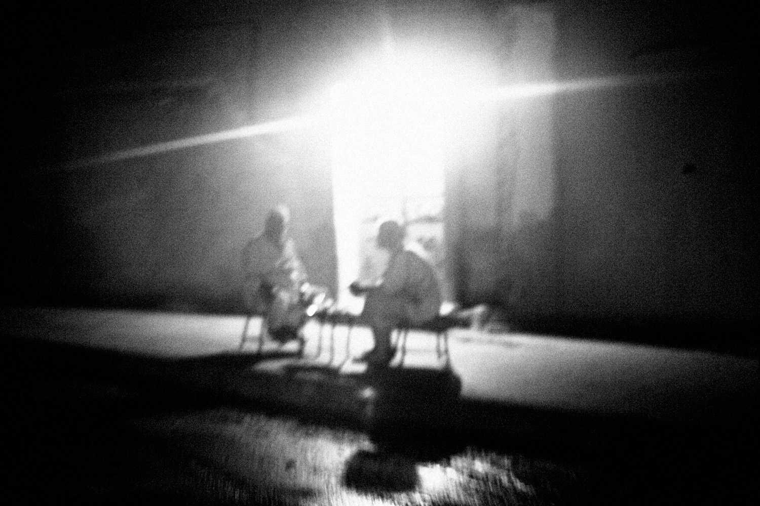 Two men sit on a street in the Syrian city of Hama, July 17, 2011.