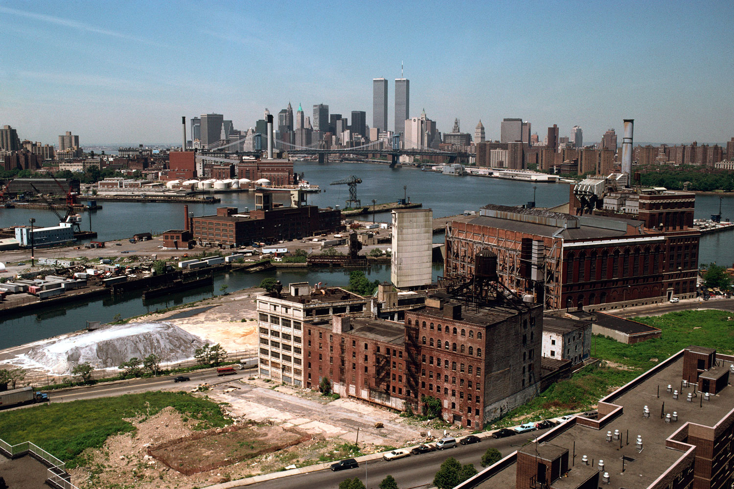 Southwest view from Independence Houses, Taylor Street at Whyte Place, Brooklyn, 1990. The building in the foreground, once a brewery, has become a housing complex. The Wallabout Canal is center, with the Brooklyn Navy Yard on the left.